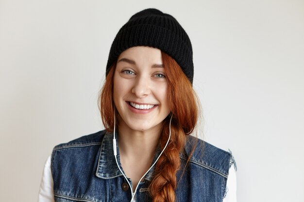 Close up shot of beautiful Caucasian young woman with braid laughing