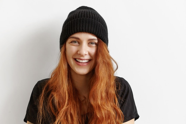 Close up shot of beautiful and charming young redhead European woman with messy loose hairstyle