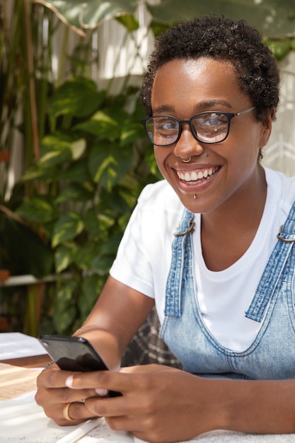 Close up shot of black beautiful smiling girl has dark short curly hair