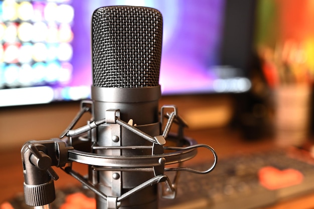 Free photo close up shot of a black condenser microphone in front of computer in a sound engineering studio