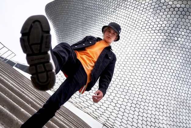 Free photo close up shot of a boy model wearing a winter outfit orange shirt in public fashion modelling