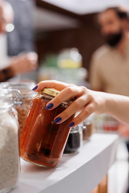 Close up shot of client at zero waste supermarket checkout counter buying organic bio food. Eco friendly local neighborhood store client purchasing preservatives free vegetable stew in jar