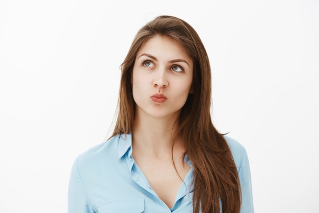 Close-up shot of dreamy brunette businesswoman posing in the studio