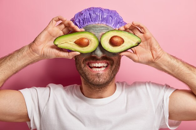 Close up shot of funny cheerful male doing his beauty routine