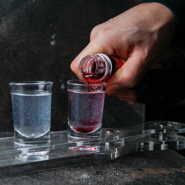 Free photo close-up shot glasses with color drinks on a glass