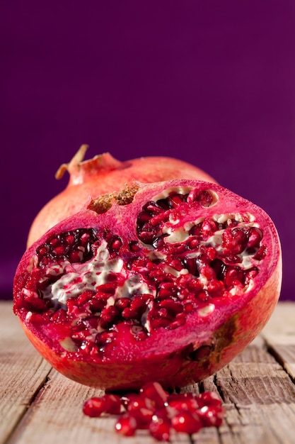 Close up shot of a juicy pomegranate whole and cut