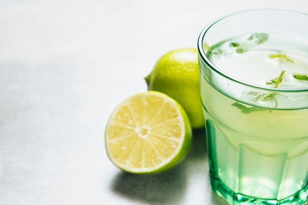 Close up shot of lemonade glass on plain background