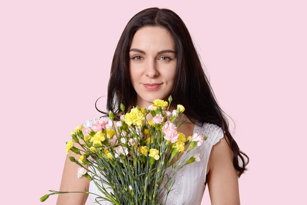 Close up shot of lovely brunette young woman with healthy soft skin