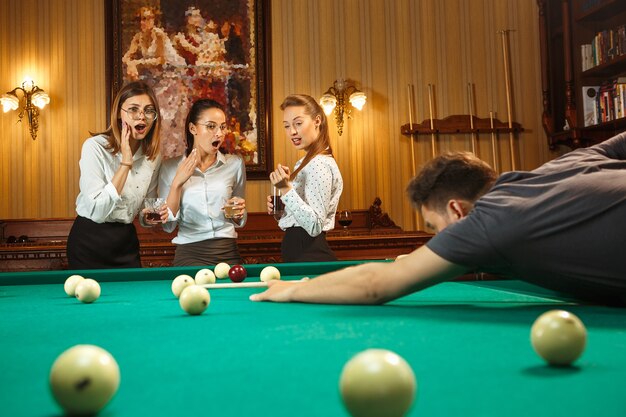 Close-up shot of a man playing billiard.