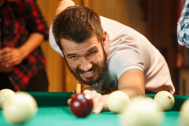 Close-up shot of a man playing billiard