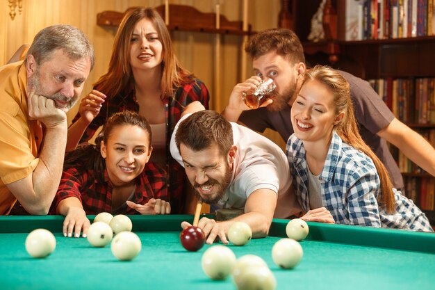 Close-up shot of a man playing billiard