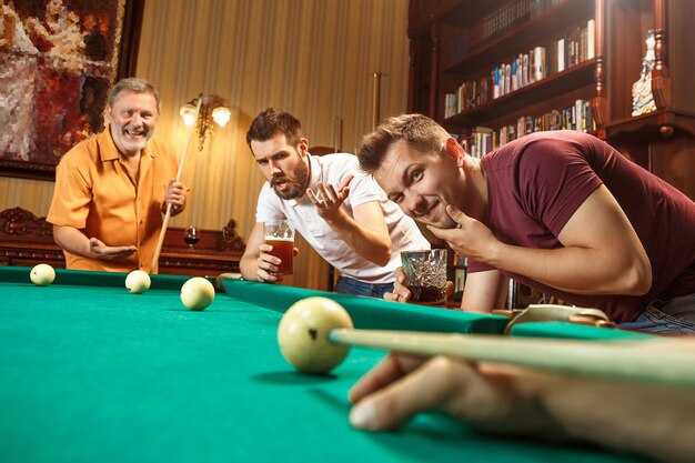 Close-up shot of a man playing billiard