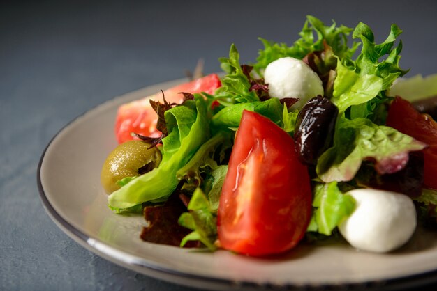 Close-up shot of plate with fresh healthy salad, diet lunch for sportsmans