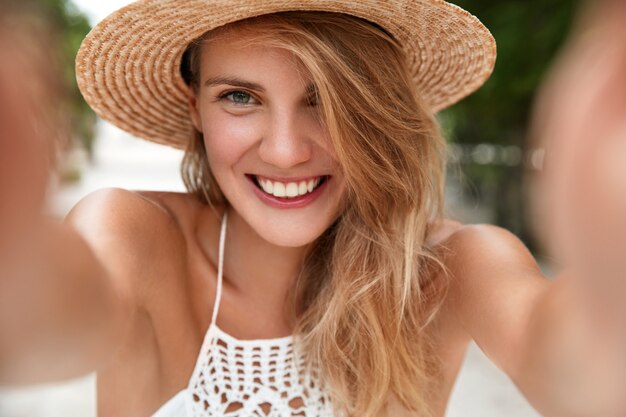Download Free Photo Beautiful Young Lady In Bright T Shirt And Hat Makes Selfie On Retrocamera Isolated On White