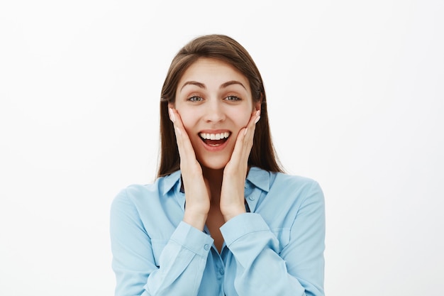 Close-up shot of satisfied brunette businesswoman posing in the studio