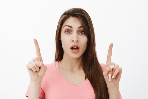 Close-up shot of surprised brunette woman posing in the studio