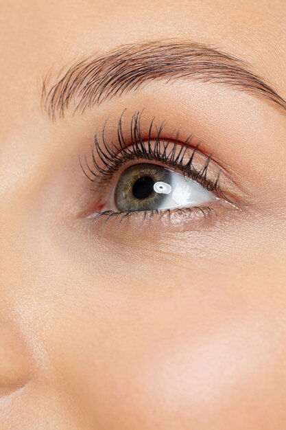 Close up shot of young woman on yellow studio