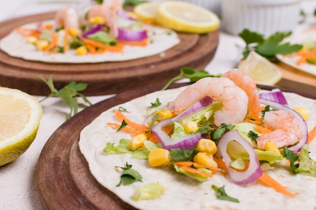 Close-up of shrimp and other food on pita