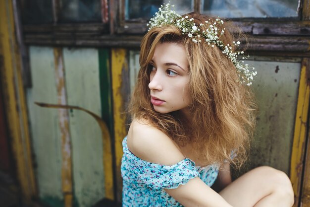 Close-up of shy girl with a wreath