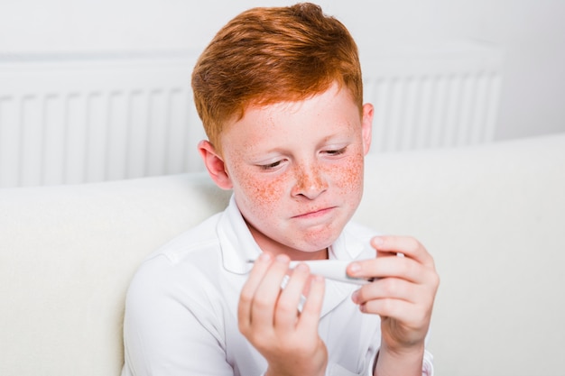 Close up sick boy with fever