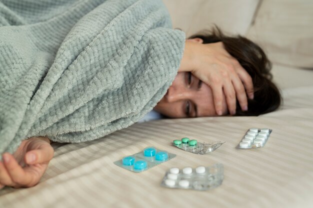 Close up sick woman laying in bed