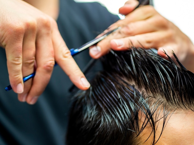 Close-up of side view customer getting a cut