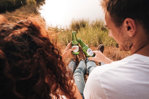 Close-up sitting couple drinking beer