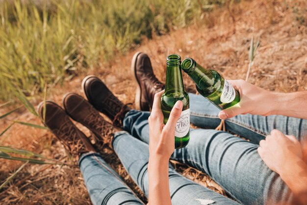 Close-up sitting couple drinking beer