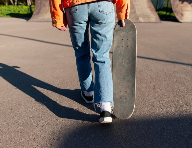 Close up skater carrying board