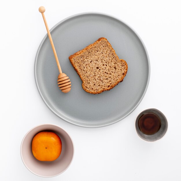 Close-up slice of bread on plate with honey