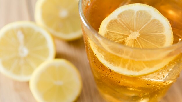 Close-up of slice of lemon in glass with drink