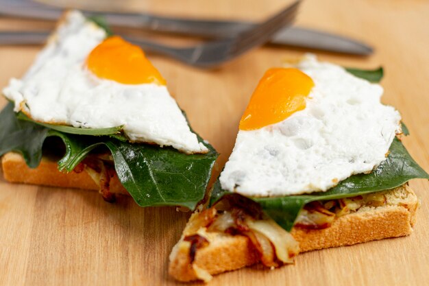 close up sliced fried egg on waffle