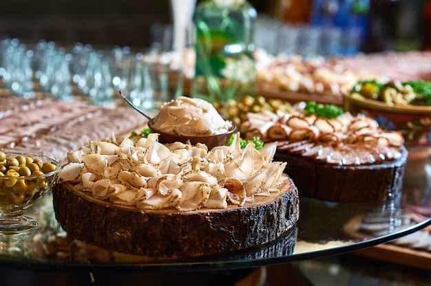 Close up of sliced spicy lard on a wooden plate on the table at the restaurant.