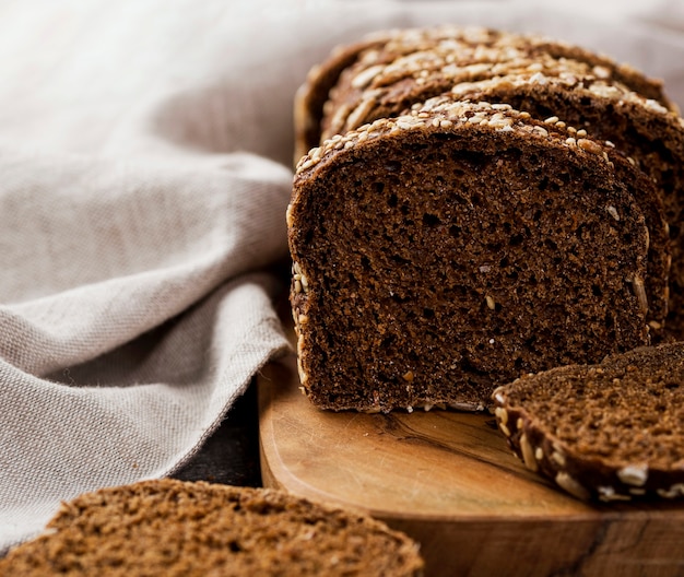 Close-up slices of bread on wooden board with cloth