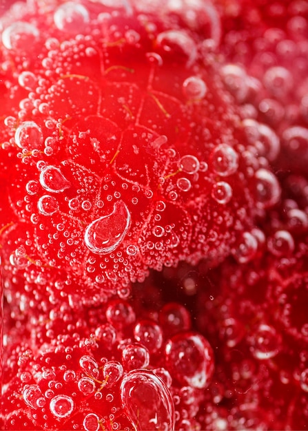 Close-up slices of raspberries in water