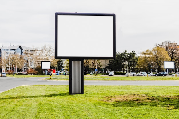 Close-up of small advertisement billboard on the city road