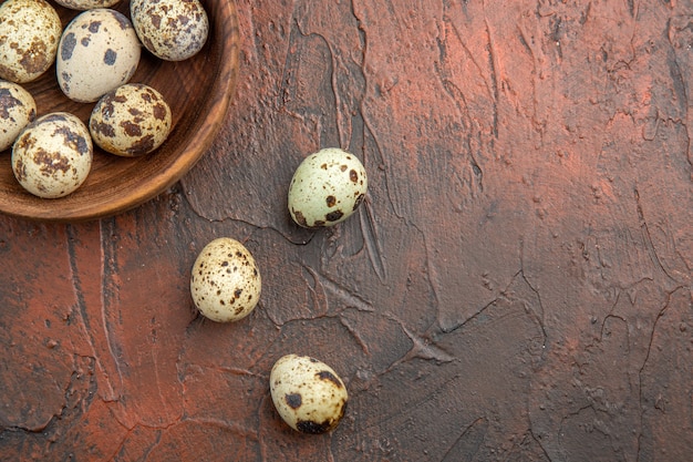 Close up on small fresh eggs in wooden pot