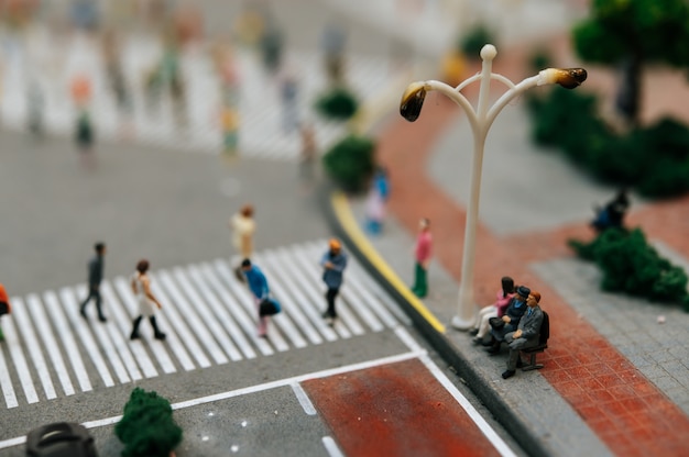 Close up of small people sitting in chairs in the park.