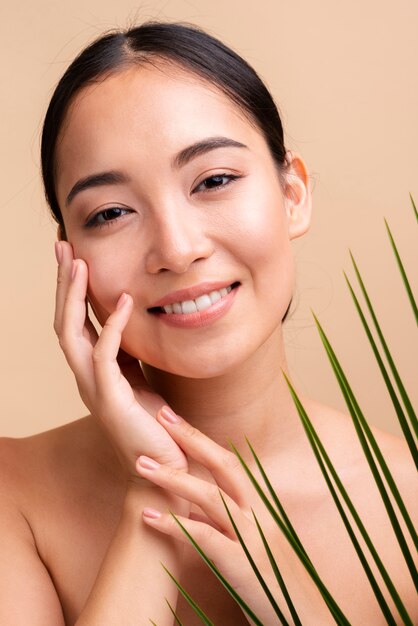 Close-up smiley asian woman with leaves