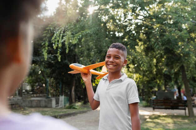 Close up smiley boy holding plane