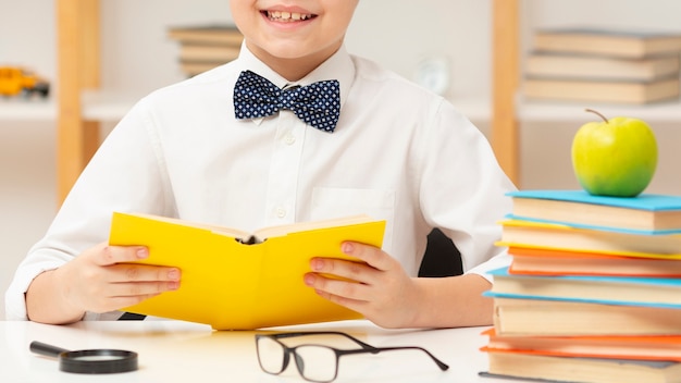 Close-up smiley boy reading