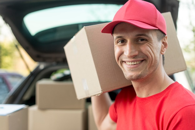 Close-up smiley delivery guy