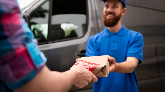 Close up smiley delivery man