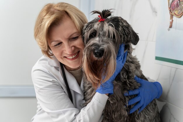 Close up smiley doctor hugging dog