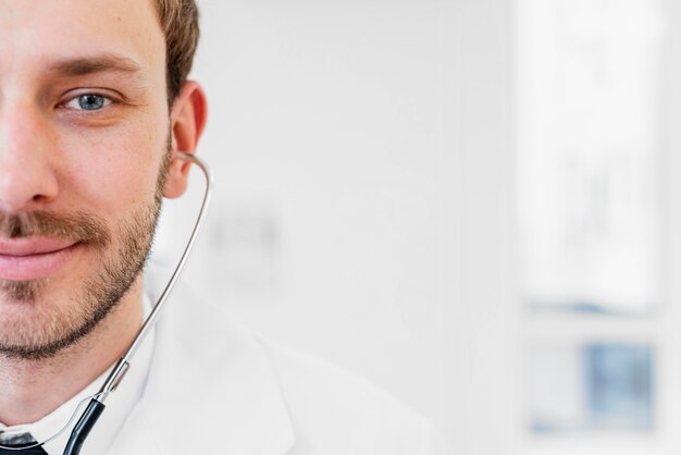 Close-up smiley doctor with stethoscope