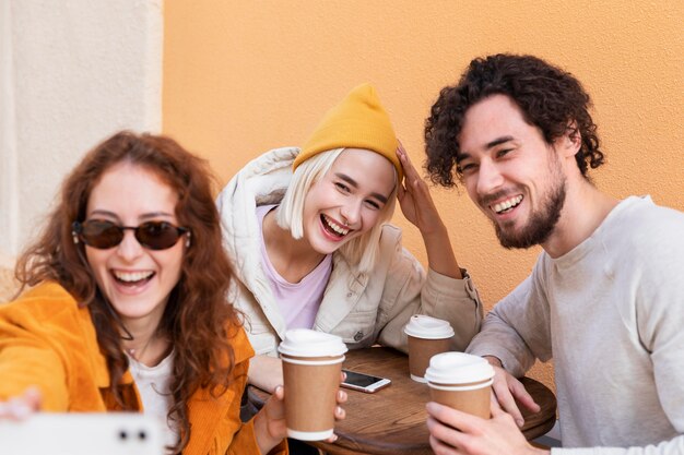 Close up smiley friends taking selfie