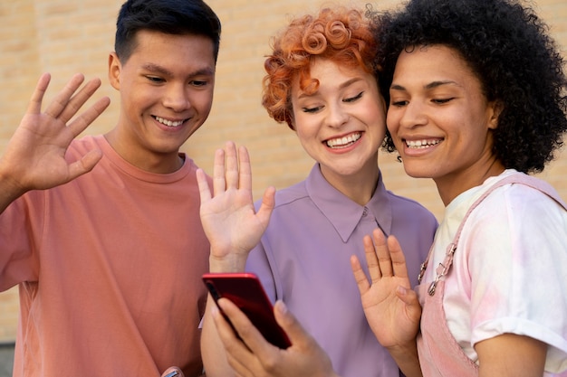 Close up smiley friends with smartphone