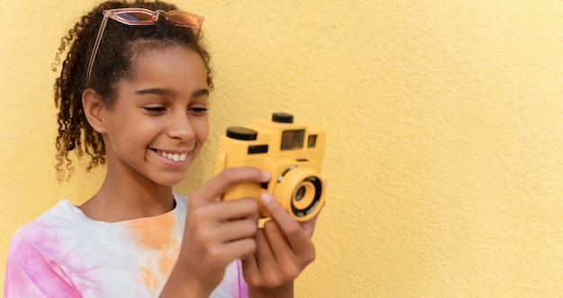 Close up smiley girl holding camera