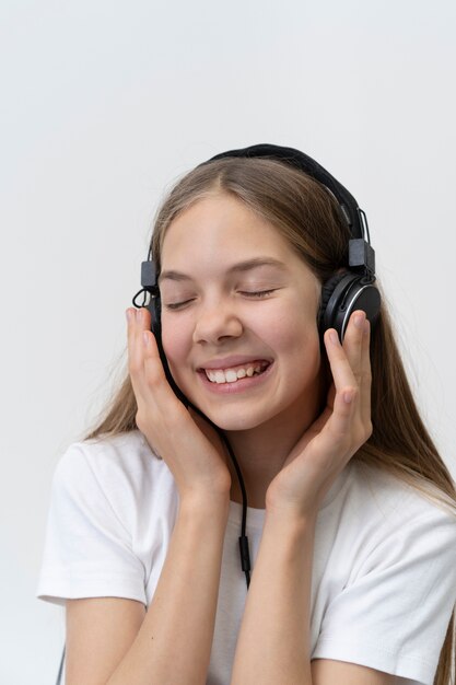 Close up smiley girl wearing headphones