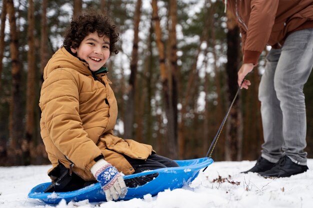 Close up smiley kid and parent outdoors